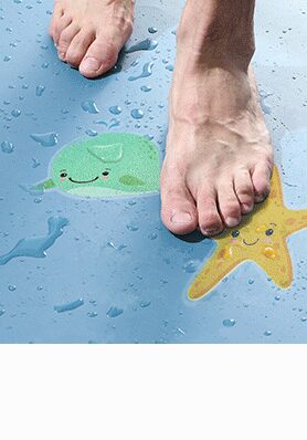 Bare feet on a bathtub floor with whale and starfish anti-slip bath stickers