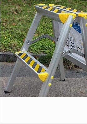 Step ladder with yellow and black hazard anti-slip tape on the steps