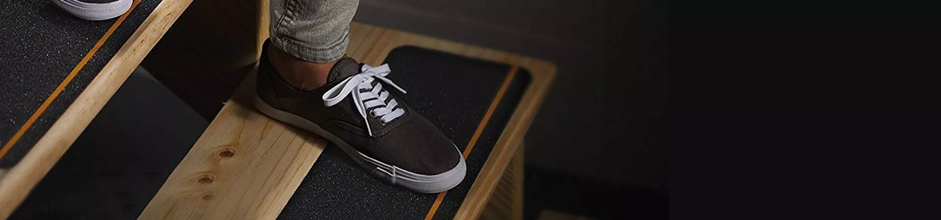 Shoe on a stair fitted with black anti-slip tape